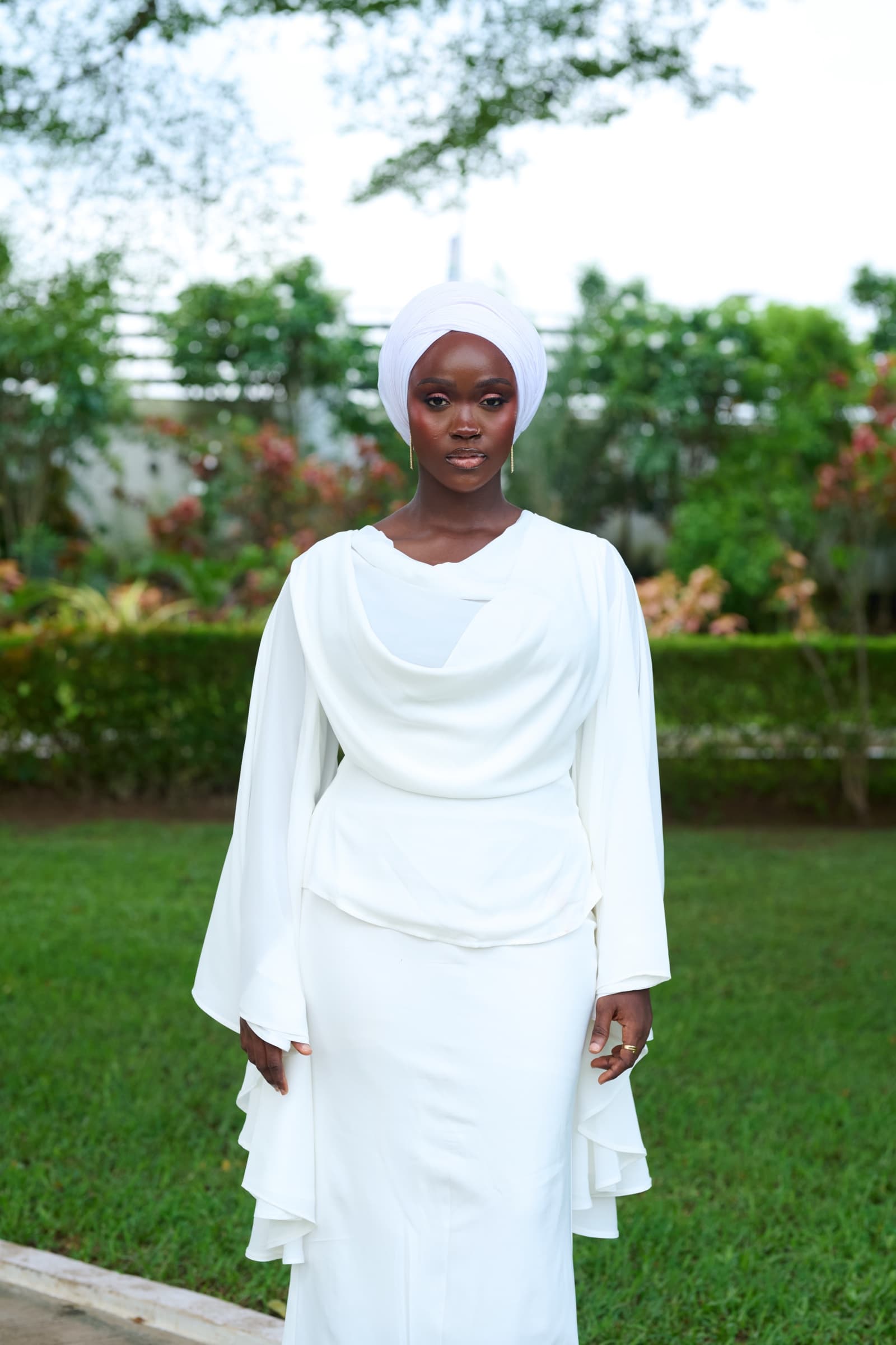 Ivory draped set with white headwrap in a garden